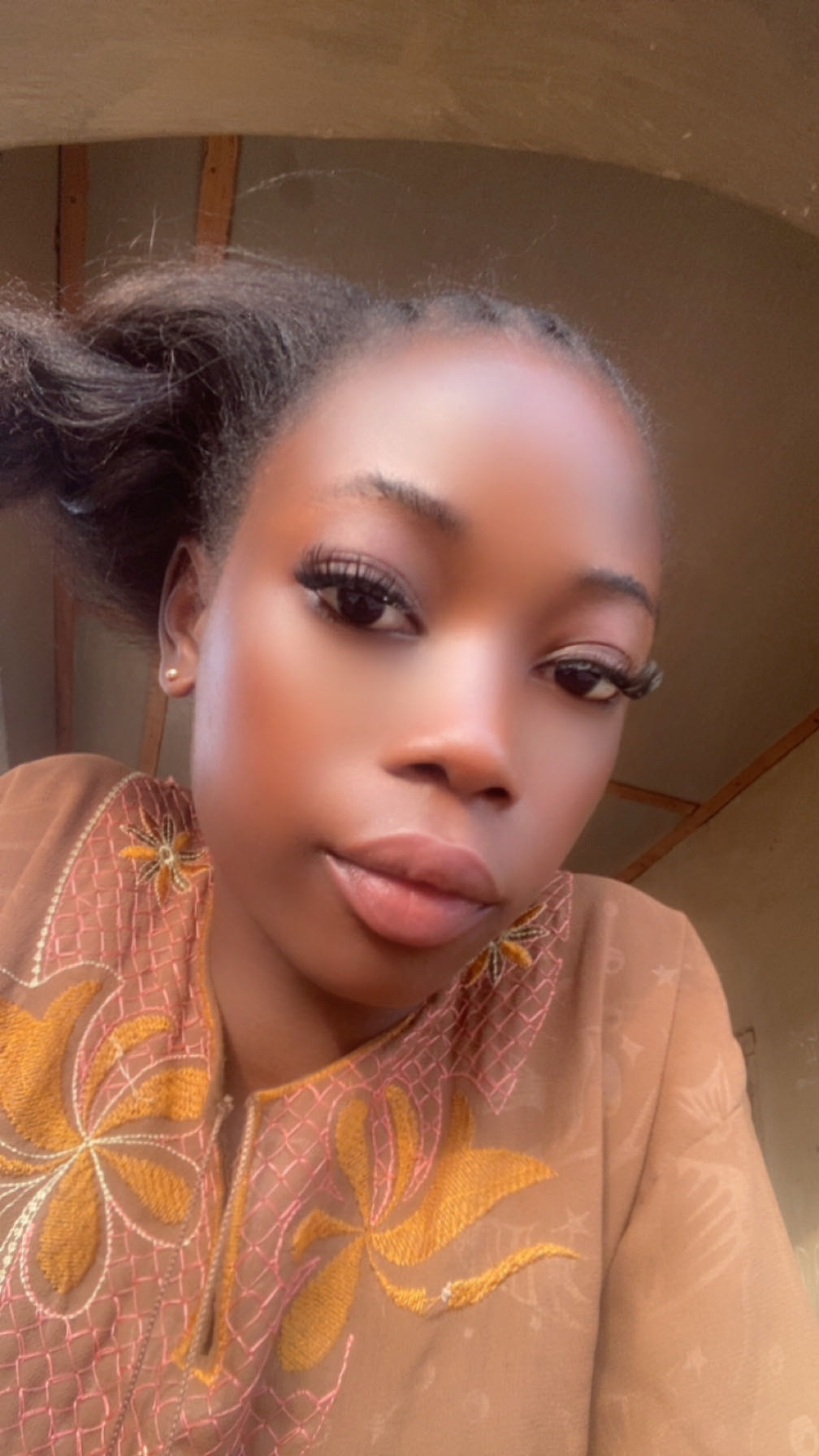 Girl from Nigeria looking into her camera, ready for a cam to cam chat