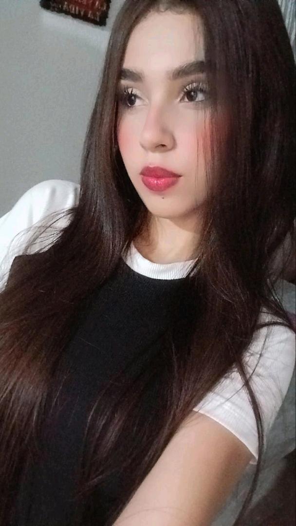 A girl from Colombia smiling into her camera on FapChatGirl